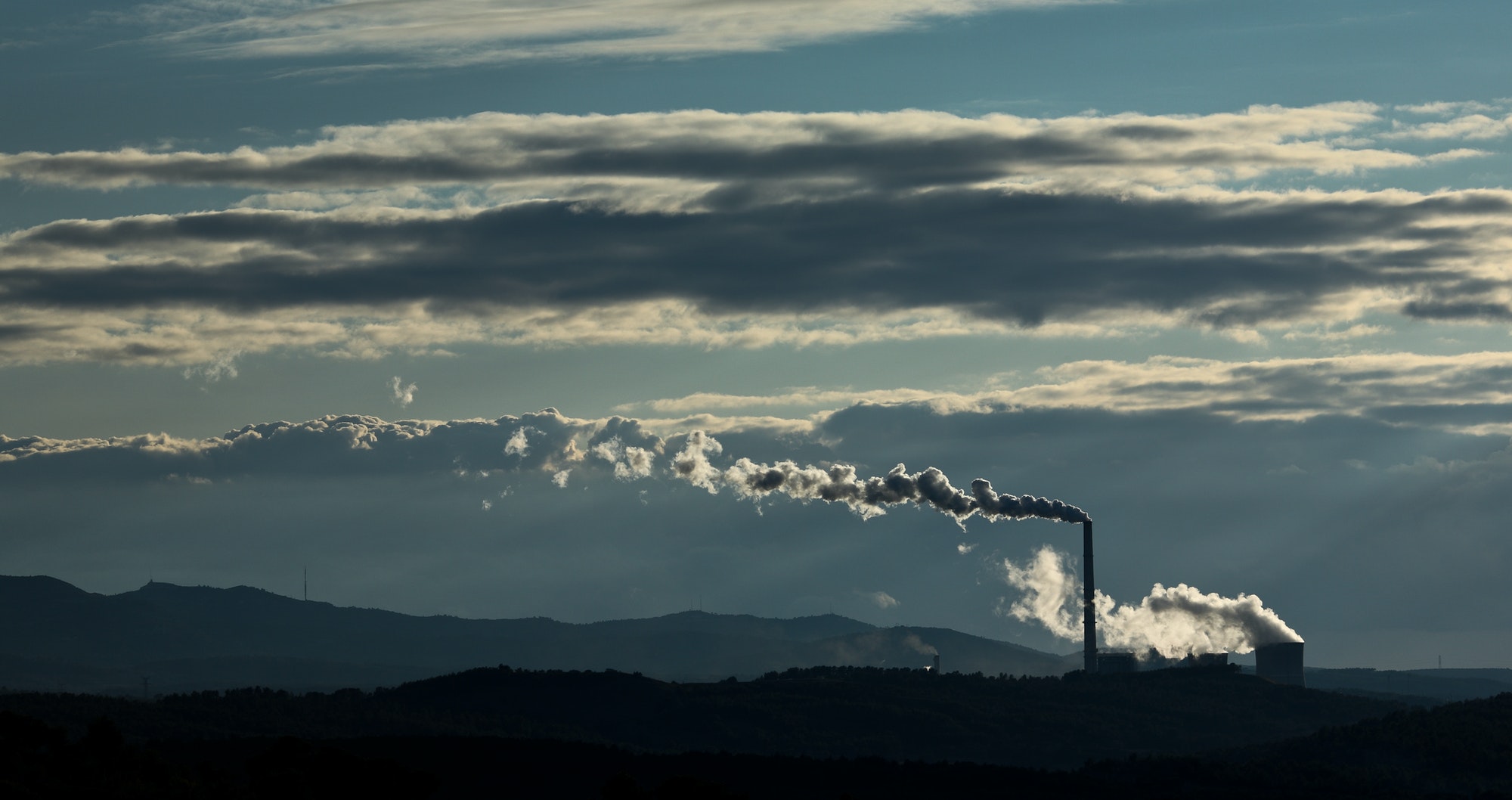 Factory polluting the environment (color toned image)