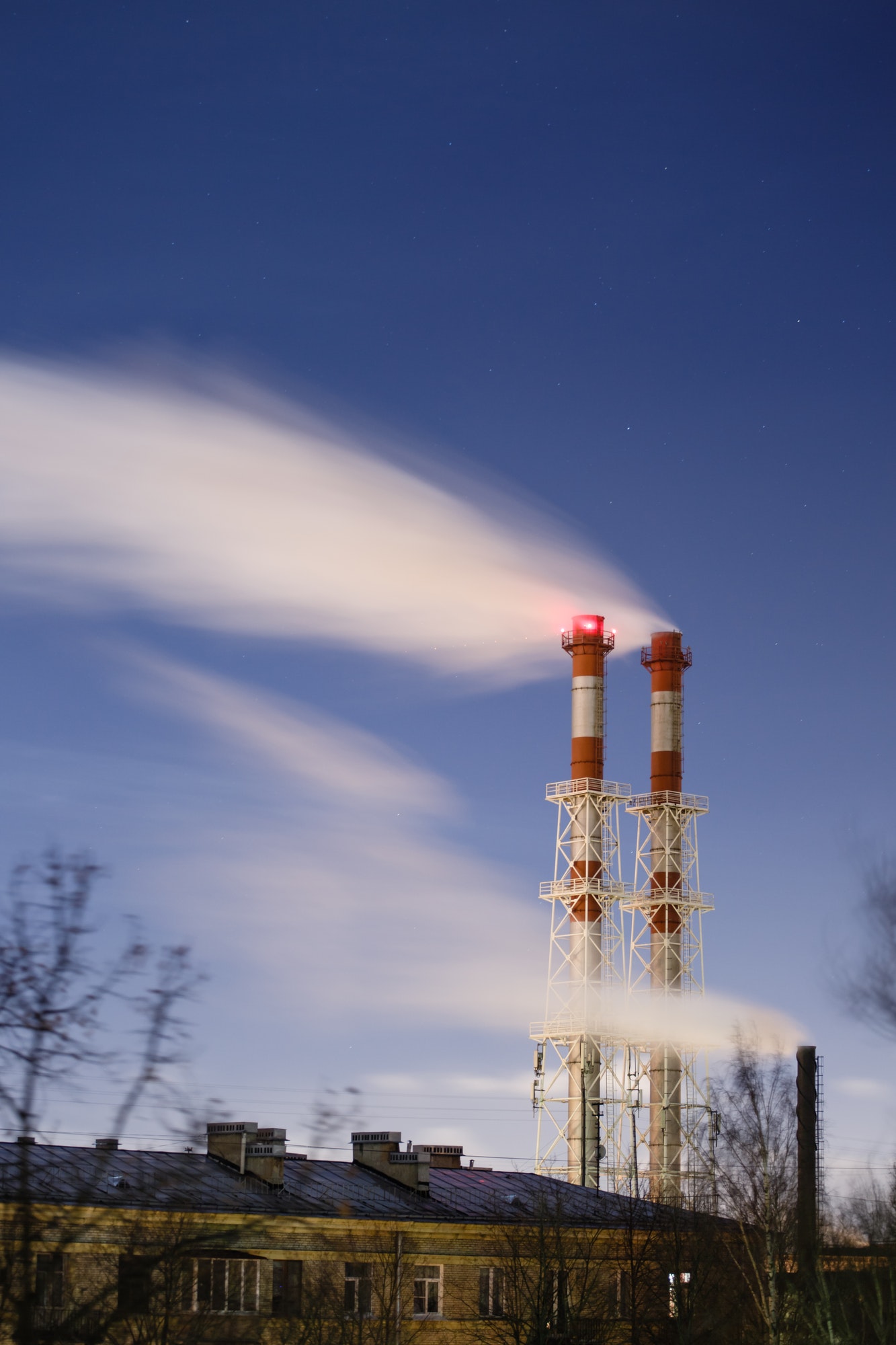 Stream of dark smoke from the chimney of factory